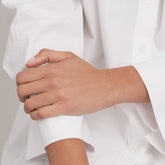 14k Yellow Gold Diamond Cut Cable Bracelet on woman's wrist